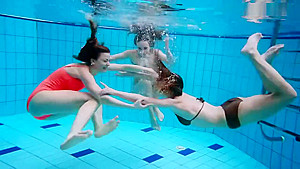 Three nude girls underwater...