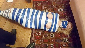 Duct tape mummy girl struggles through...